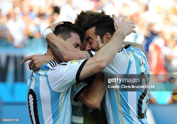 Lionel Messi of Argentina is congratulated by team-mate Ezequiel Lavezzi after scoring the opening goal