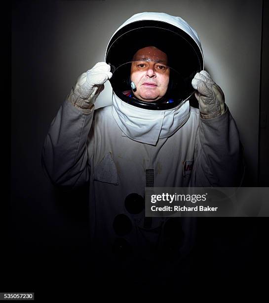 Portrait of space-suited frequent flyer astronaut Alan Watts in his north London home, England. Alan runs an electrical company and qualified for a...