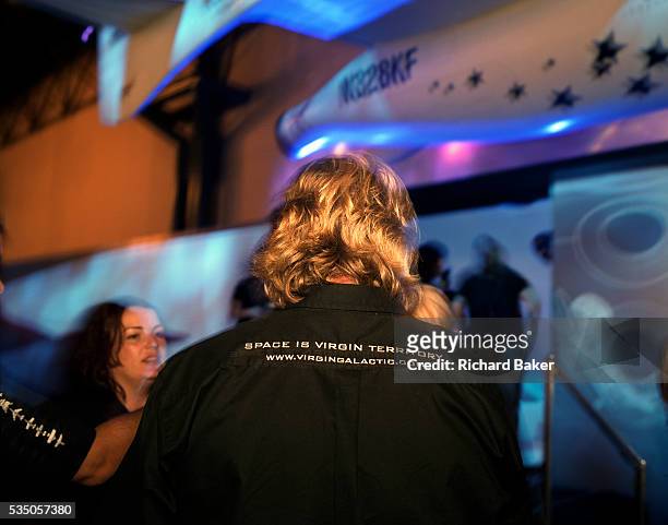 The back of famous greying-blonde head belonging to Sir Richard Branson of Virgin Galactic is seen during SpaceShipTwo's replica model unveiling at...