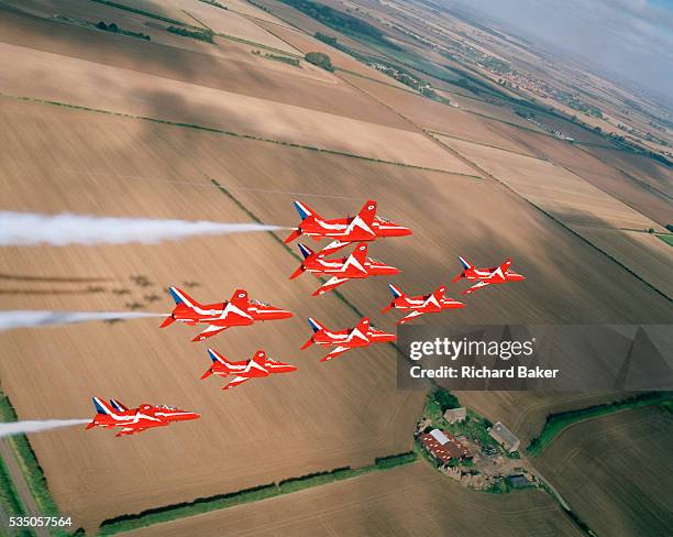 Banking slowly left over the agricultural Lincolnshire countryside are the elite 'Red Arrows', Britain's prestigious Royal Air Force aerobatic team,...