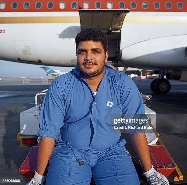 Bahrani baggage-handler employed by SABTCO pauses during his shift at Bahrain International airport. Having loaded luggage and cargo into the hold of...