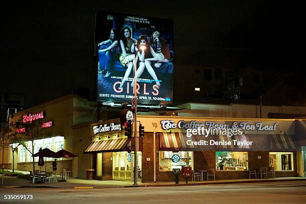 Coffee bean and tea leaf coffee house at night under a large billboard for HBO's "Girls" TV show in west Los Angeles