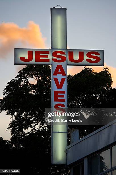New Zealand, North Island, Bay of Plenty. Te Puke main street. "Jesus Saves", advertisment sign on the streets in the late afternoon light