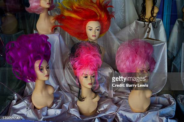 Wigshop and vintage clothing shop window, day glo nylon wigs. Hollywood Boulevard, California