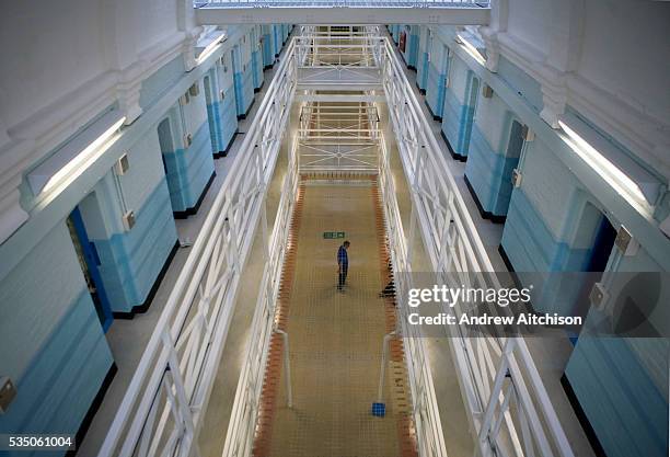 One man standing in the main hall of the newly refurbished E wing at Wandsworth prison. HMP Wandsworth in South West London was built in 1851 and is...