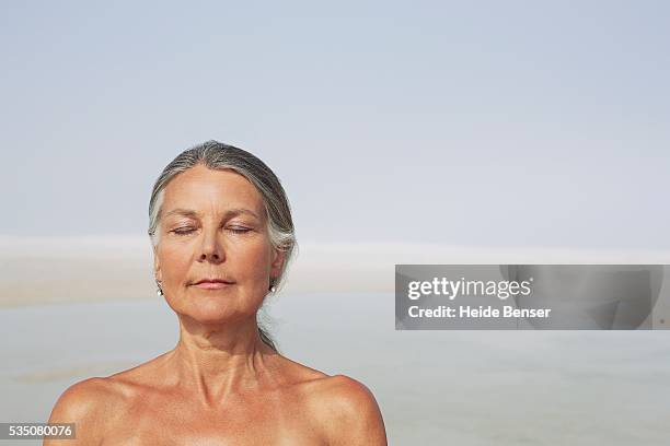 woman meditating - beach clear sky stock pictures, royalty-free photos & images