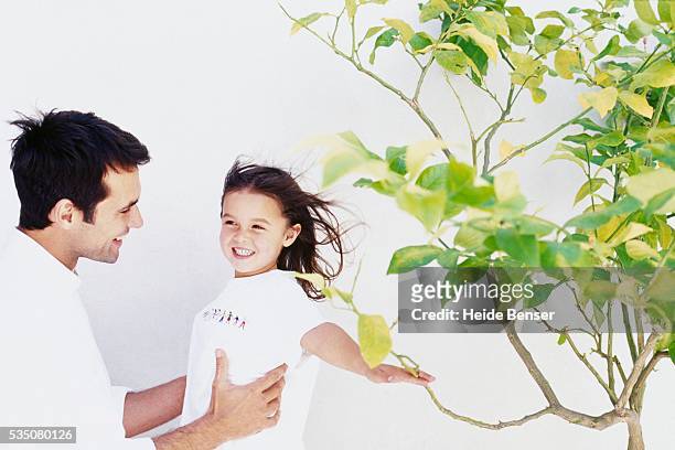 father carrying daughter - wellness kindness love stock pictures, royalty-free photos & images