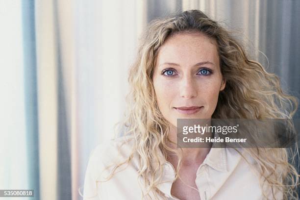 woman with pensive expression - blonde blue eyes stock-fotos und bilder