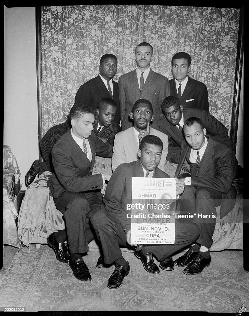 Men With Ahmad Jamal Sign