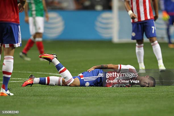 Derlis Gonzalez of Paraguay lies injured during the International Friendly between Mexico and Paraguay at Georgia Dome on May 28, 2016 in Atlanta,...