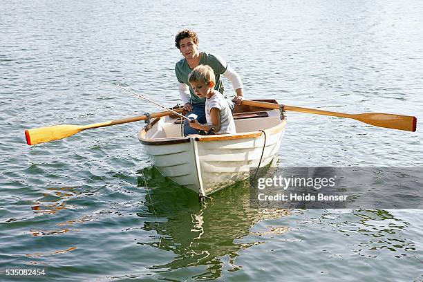 father and son in rowboat - rowboat bildbanksfoton och bilder