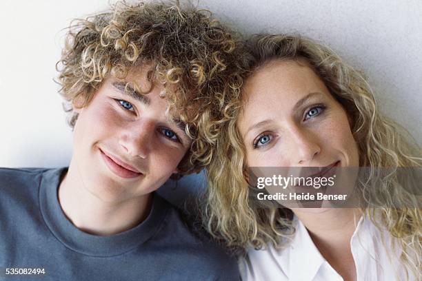 mother and son with heads together - 40 year old woman blonde blue eyes stock pictures, royalty-free photos & images