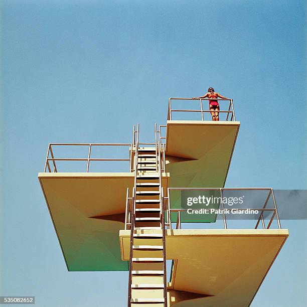 woman standing on diving platform - diving platform stock pictures, royalty-free photos & images