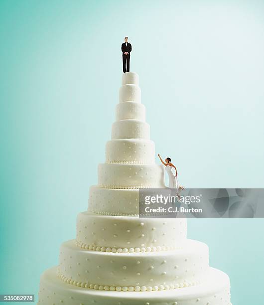 bride climbing wedding cake - wedding cakes stock pictures, royalty-free photos & images