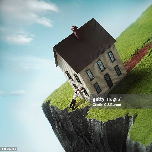 man leaning against house near cliff - fall prevention stock-fotos und bilder