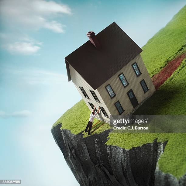 man leaning against house near cliff - home ownership concept stock pictures, royalty-free photos & images