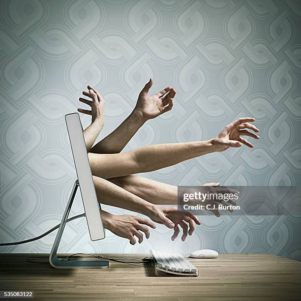 hands reaching out of a computer screen - ominous computer stock pictures, royalty-free photos & images