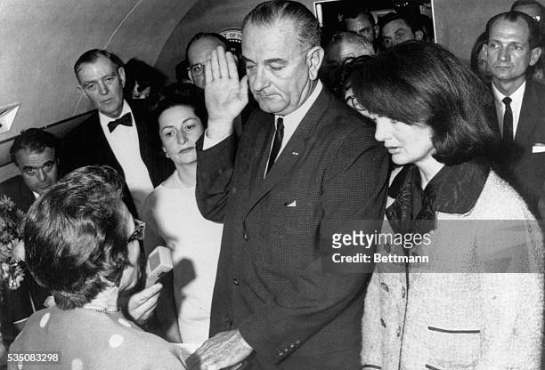 Vice President Lyndon B Johnson is sworn in to the office of the Presidency aboard Air Force One in Dallas, Texas, hours after the assassination of...