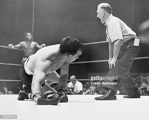 Chicago, IL- As Sugar Ray Robinson rests in a neutral corner, stricken middleweight champion Gene Fullmer struggles to rise, while referee Frank...