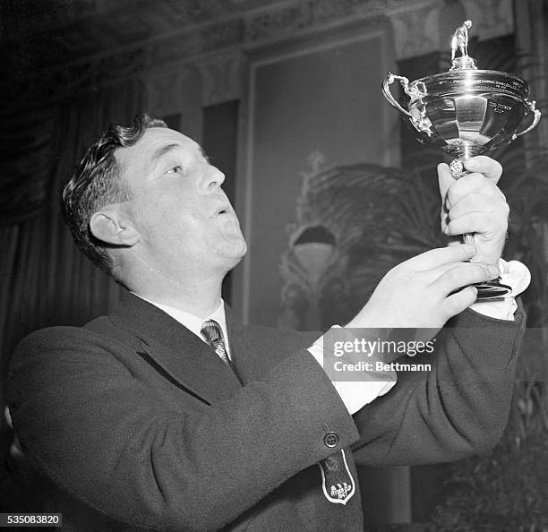 New York, NY- Fred Daly, British Open Golf Champion and member of the British Ryder Cup team, admiringly 'eyes' the coveted Ryder Cup at the dinner...