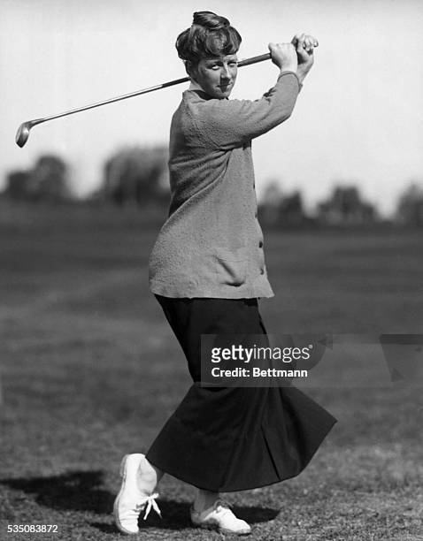 Photograph of Marion Hollins, winner of 1921 Women's U.S. Amateur Championship and owner of Pasatiempo Golf Course. She poses as if she has just...
