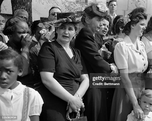 Mourners watch the funeral procession of Franklin Delano Roosevelt as it makes its way up Constitution Avenue to the White House for the funeral...