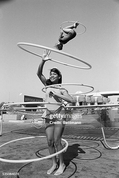 Los Angeles, CA- National hula-hoop champion Sandra Gaylord spins her hoops while world professional trampoline champion Judy Johnson does her thing,...