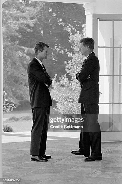 President John F. Kennedy and his brother, Attorney General Robert F. Kennedy, speak together after participating in a ceremony at the White House in...