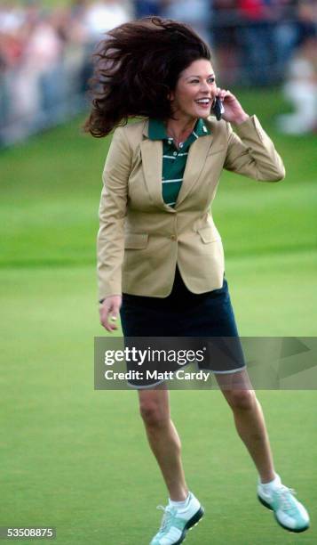 Celebrity golfer Catherine Zeta-Jones celebrates whilst talking on a mobile phone on the final day of The All-Star Cup Celebrity Golf tournament at...