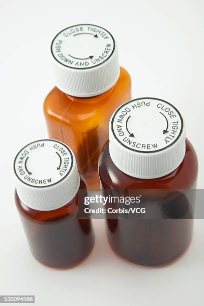 medicine bottles with child-proof lids - child proofing stock pictures, royalty-free photos & images