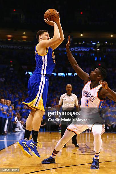 Klay Thompson of the Golden State Warriors shoots the ball against Anthony Morrow of the Oklahoma City Thunder during the second half in game six of...