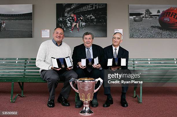 Former AFL players Colin Robertson, Bob Davis and Bill Young pose with the medals they will present during the Official 2005 Premiership Cup and...