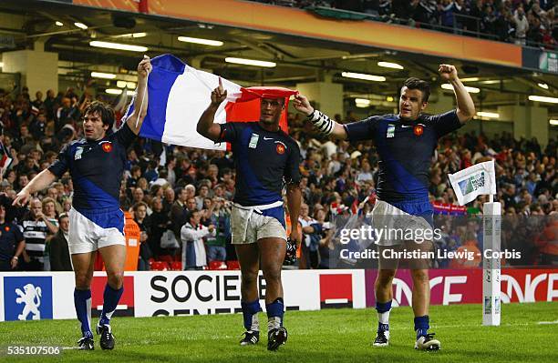 France's winger Christophe Dominici, France's flanker Thierry Dusautoir and France's fullback Damien Traille celebrate after the IRB World Cup rugby...