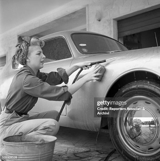 Italian actress Isa Barzizza washing a car. Italy, 1952