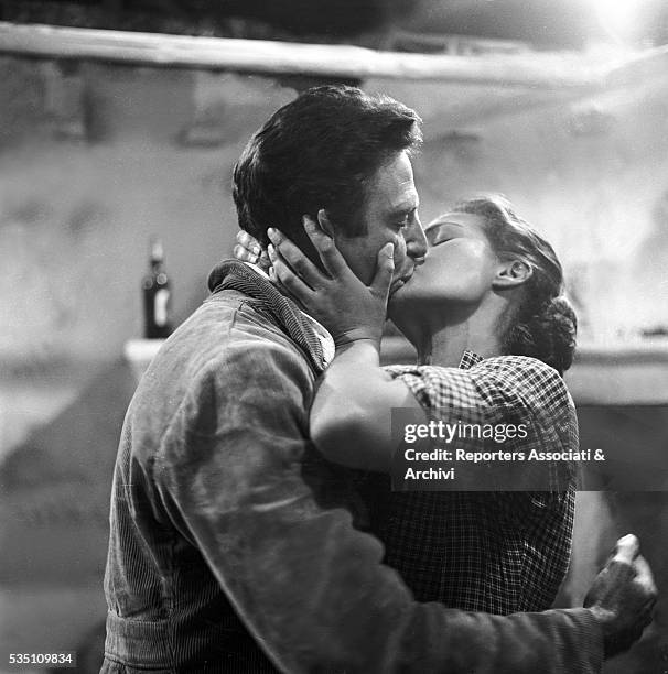 Italian actor Raf Vallone kissing German actress Eva Kotthaus in Uragano sul Po. Italy, 1956