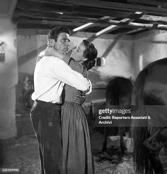 Italian actor Raf Vallone kissing German actress Eva Kotthaus in Uragano sul Po. Italy, 1956