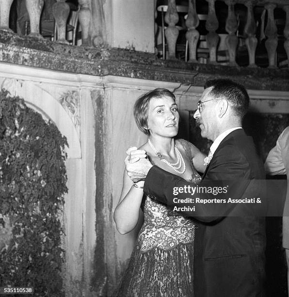 Italian writer and director Mario Soldati - winner of the Strega Prize - and his wife Giuliana Kellermann dancing during the awarding ceremony held...