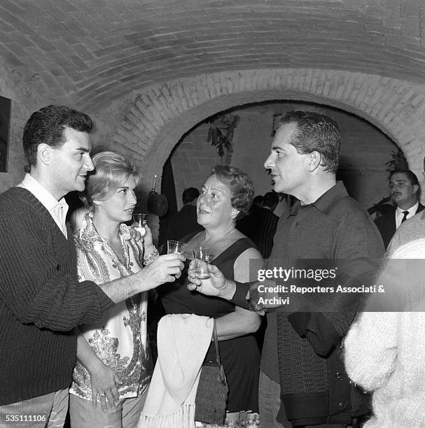 Italian actor Rossano Brazzi and his wife Lidia Bertolini toasting at the party held in the house of Italian-born Swiss singer Teddy Reno and his...