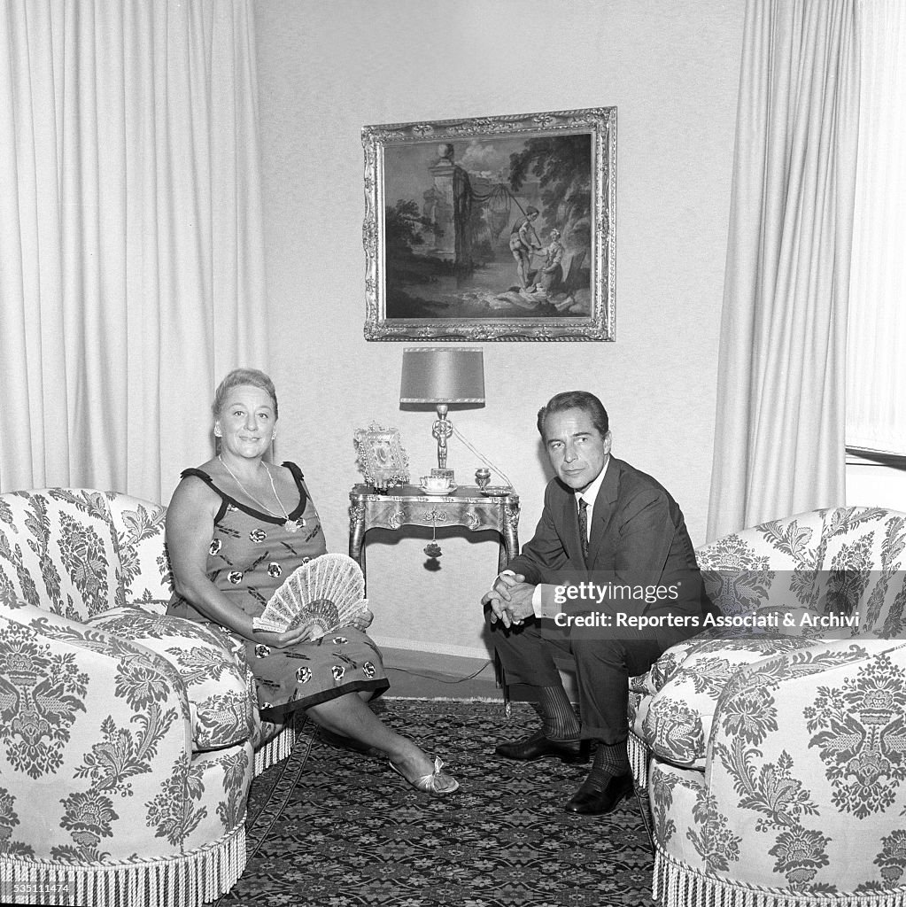 Rossano Brazzi and Lidia Bertolini sitting in the living room at home