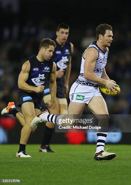 Patrick Dangerfield of the Cats runs with the ball during the round 10 AFL match between the Carlton Blues and the Geelong Cats at Etihad Stadium on...