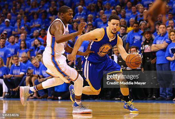 Klay Thompson of the Golden State Warriors drives against Kevin Durant of the Oklahoma City Thunder during the fourth quarter in game six of the...