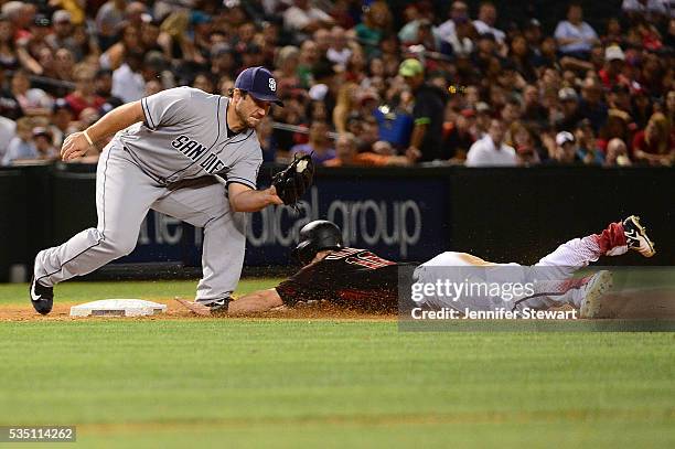 Chris Owings of the Arizona Diamondbacks safely steals third base under Brett Wallace of the San Diego Padres in the seventh inning at Chase Field on...