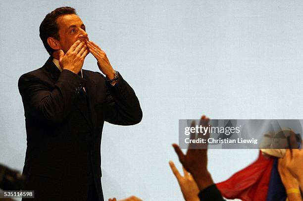 Union for a Popular Movement leader Nicolas Sarkozy is greeted by his supporters after the announcement of his victory in the second and final round...