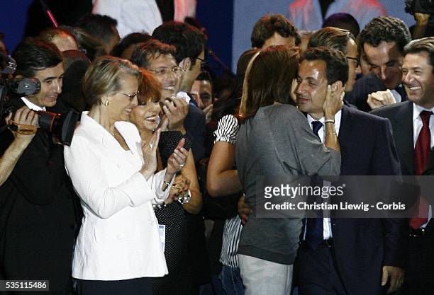 Defense Minister Michelle Alliot-Marie watches as Cecilia Sarkozy kisses her husband, Nicolas Sarkozy at the concert celebrating his victory in the...