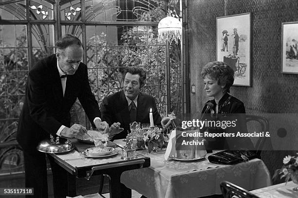 Italian actors Carla Gravina and Marcello Mastroianni sitting at the table in the film The Terrace. 1980