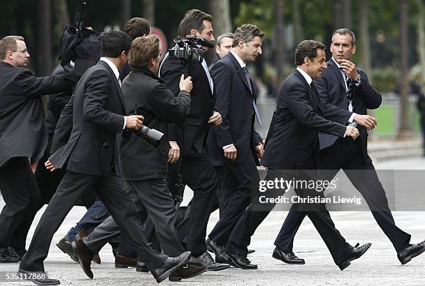 France's new President Nicolas Sarkozy goes to supporters on the Avenue des Champs Elysees.