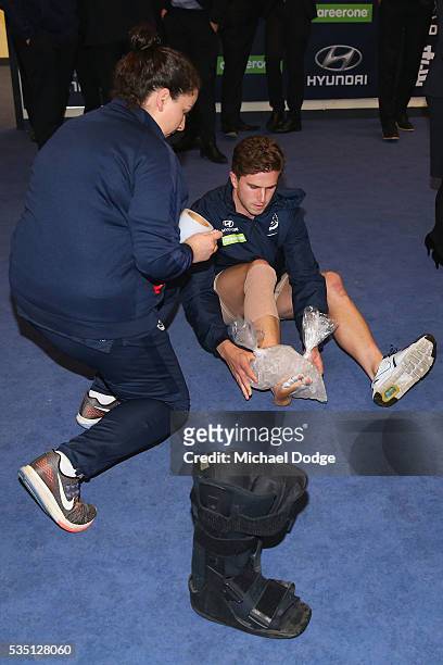 Marc Murphy of the Blues takes off his moonboot and ices his foot after their win in the round 10 AFL match between the Carlton Blues and the Geelong...