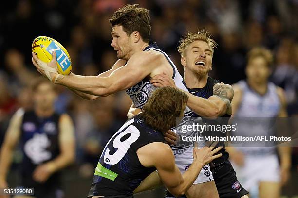 Patrick Dangerfield of the Cats is tackled by Liam Sumner and Dennis Armfield of the Blues during the 2016 AFL Round 10 match between the Carlton...