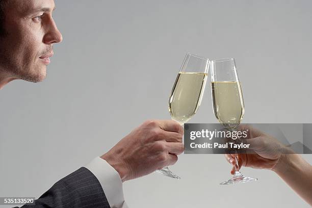 couple toasting with champagne - woman holding champagne stock-fotos und bilder