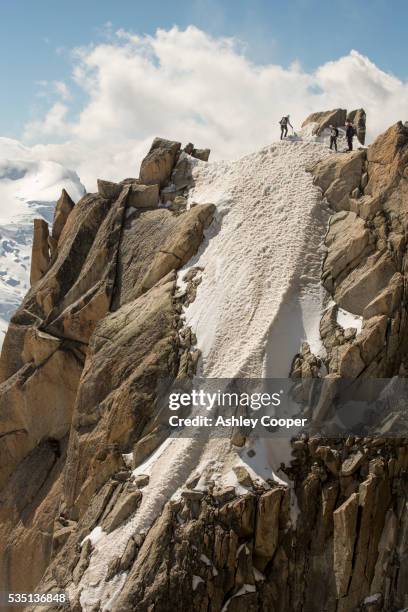 climbers on the cosmiques arete on the aiguille du midi above chamonix, france. - permafrost stock-fotos und bilder